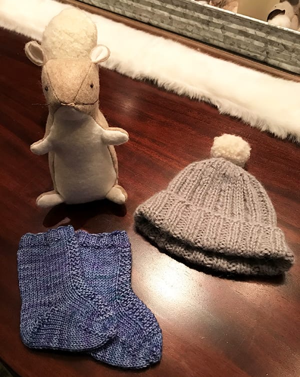 Knitted hat and socks with squirrel stuffed animal