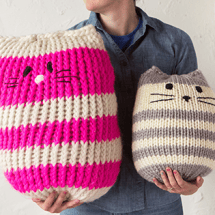 Hillary holding two Mini Kitty Poufs