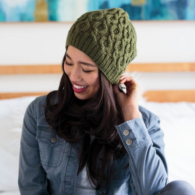 Twisting Trails Hat knit in the Fiddlehead color of Twill yarn.