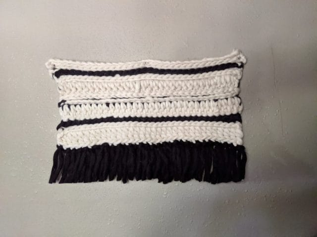 Hilary's crocheted wall hanging, made in alternating stripes of black and white.