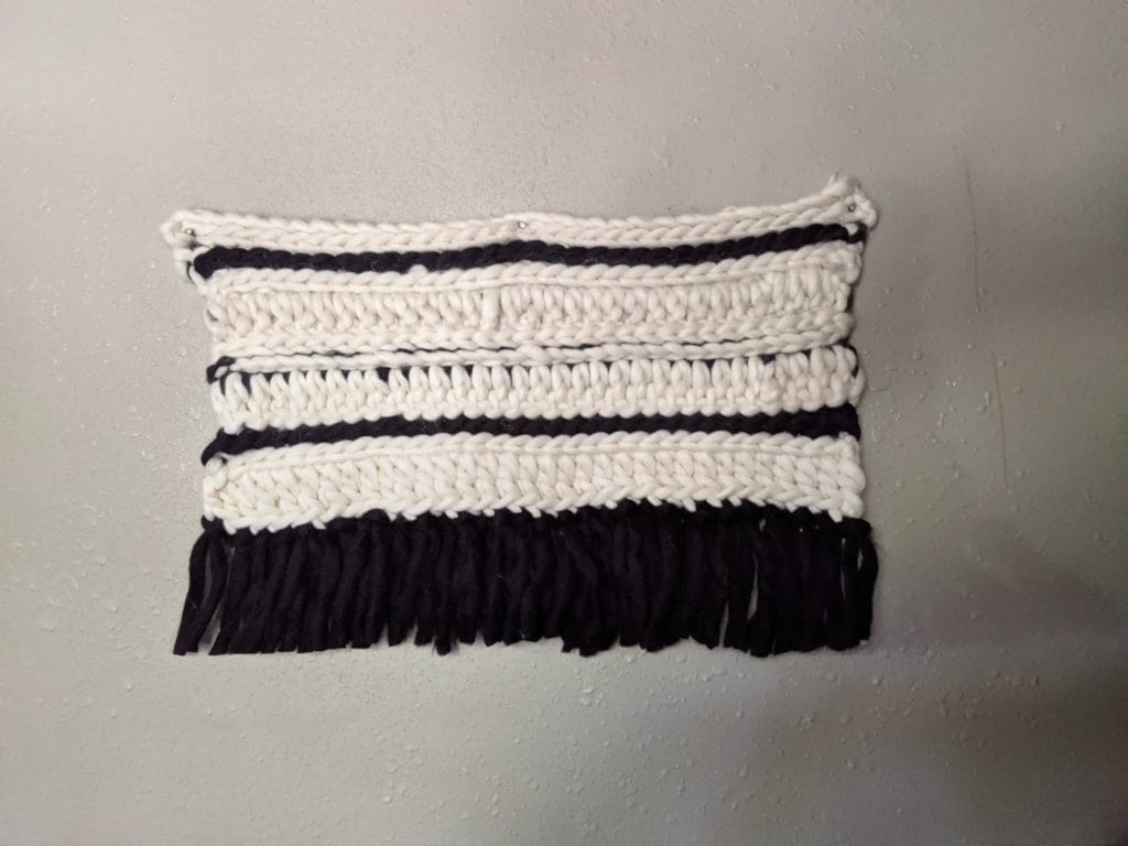 Hilary's crocheted wall hanging, made in alternating stripes of black and white.