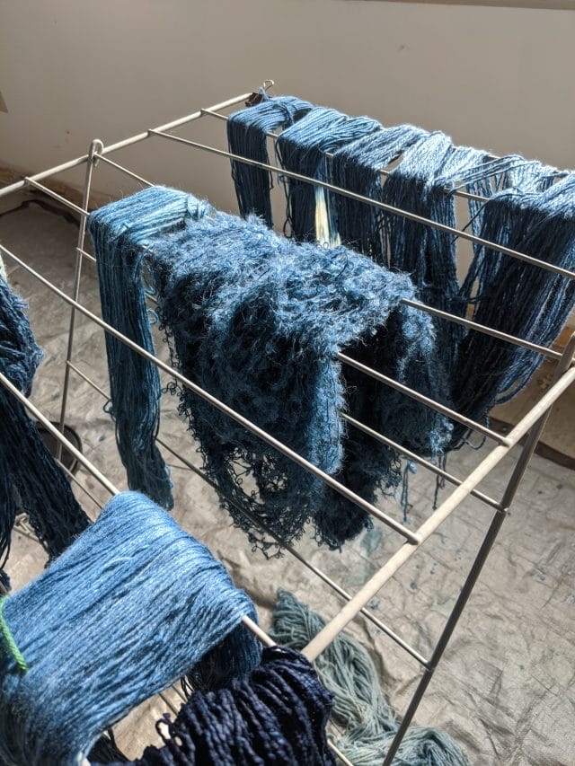 a rack of drying indigo-dyed yarns