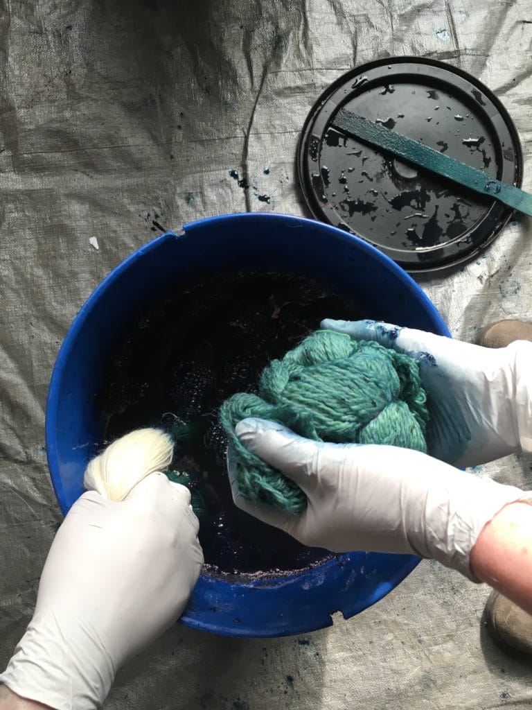 Hands Dyeing yarn with indigo