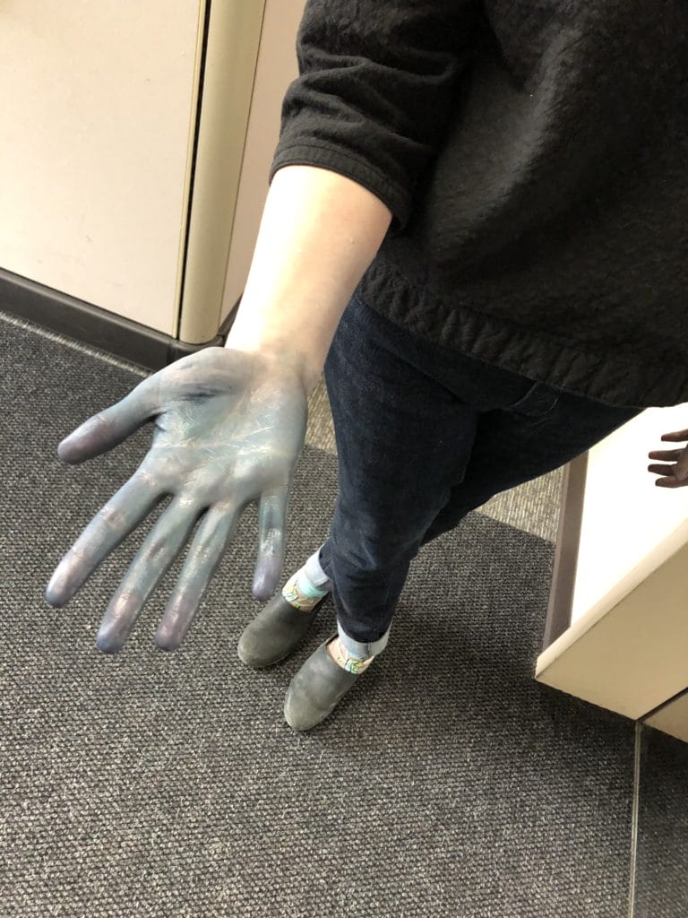 a hand, stained blue with indigo dye