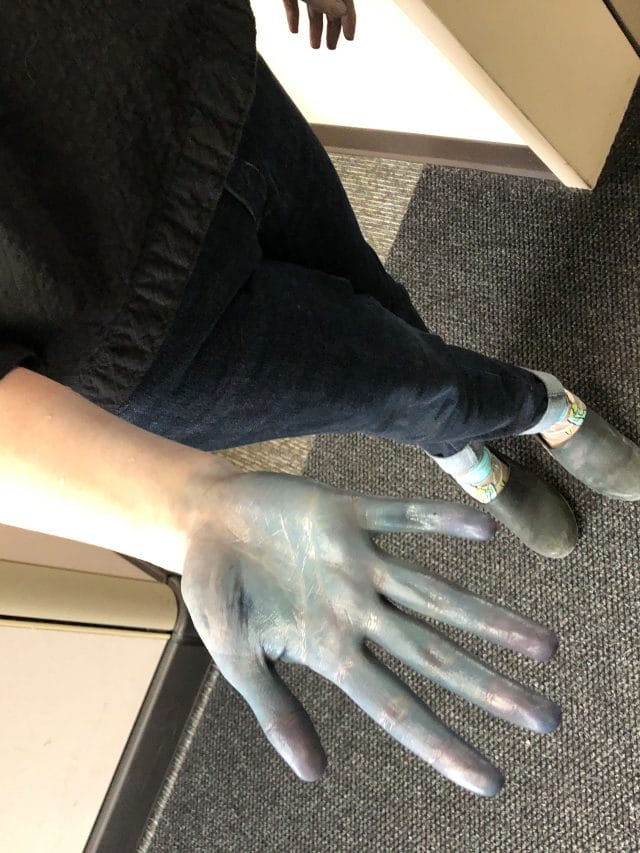a hand, stained blue with indigo dye
