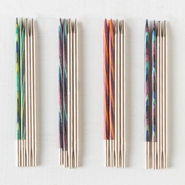 On a white background, four groups of interchangeable knitting needles in various styles.