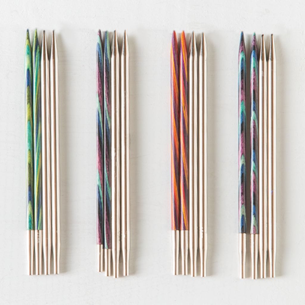 On a white background, four groups of interchangeable knitting needles in various styles.