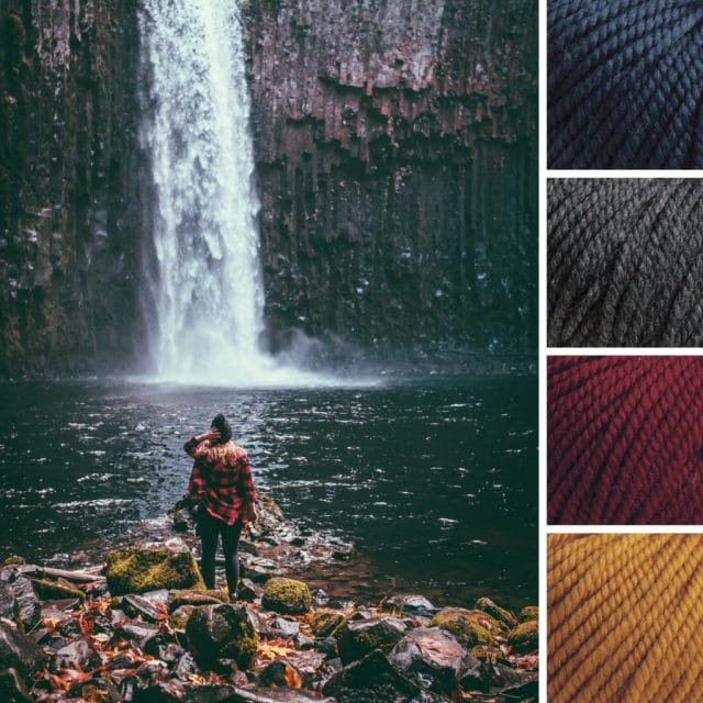 An autumn color palette: To the left, the inspiration photo consists of a waterfall against dark rocks falling into a pool that touches rocks where a person in a red plaid flannel and black beanie is standing. To the right, four yarn swatches from Twill in the following colors: deep blue, dark gray, dark red, and gold.