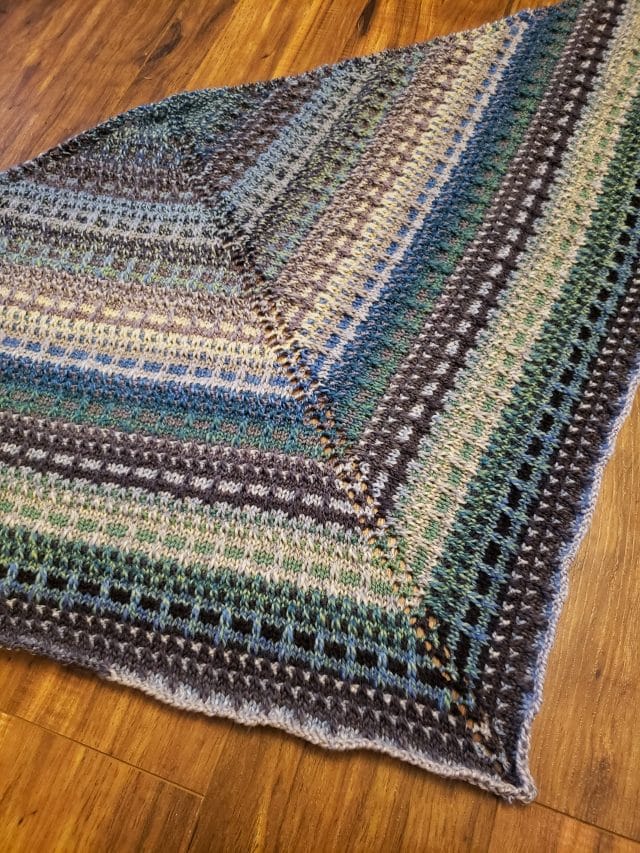 A knitted shawl made in Chroma Twist worsted.