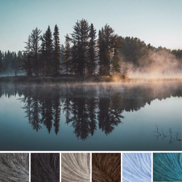 A serene image of an island in a lake and its reflection, accompanied by yarn in the colors: medium gray, black-gray, light fog gray, warm brown, icy light blue, and turquoise.