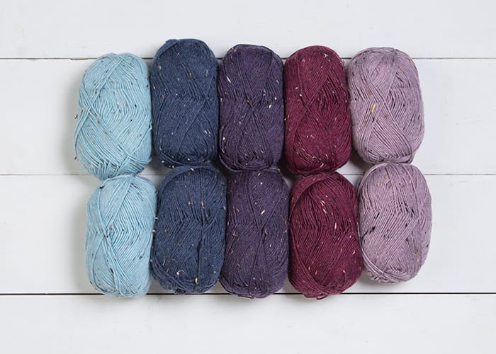 Ten balls of Stroll Tweed in berry colors