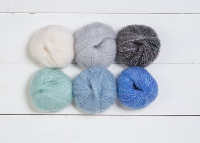 Six balls of Aloft mohair yarn in white, gray, black, mint, light blue, medium blue
