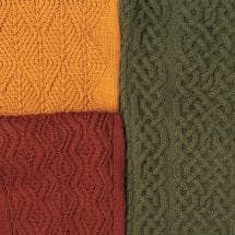 A trip of richly colored cable sweaters.