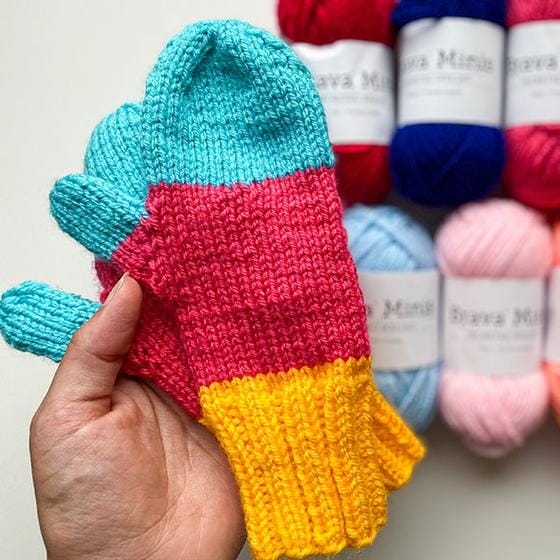hand-knitted colorblocked mittens in teal, hot pink, and gold