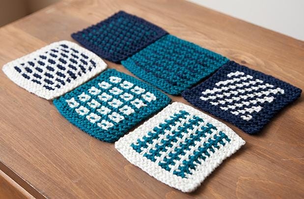 knitted coasters made in shades of blue and white