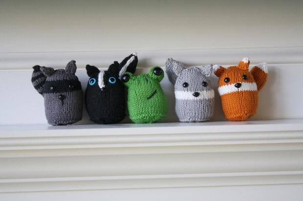 knitted stuffed animals that look like spheres with features: raccoon, skunk, frog, squirrel, fox