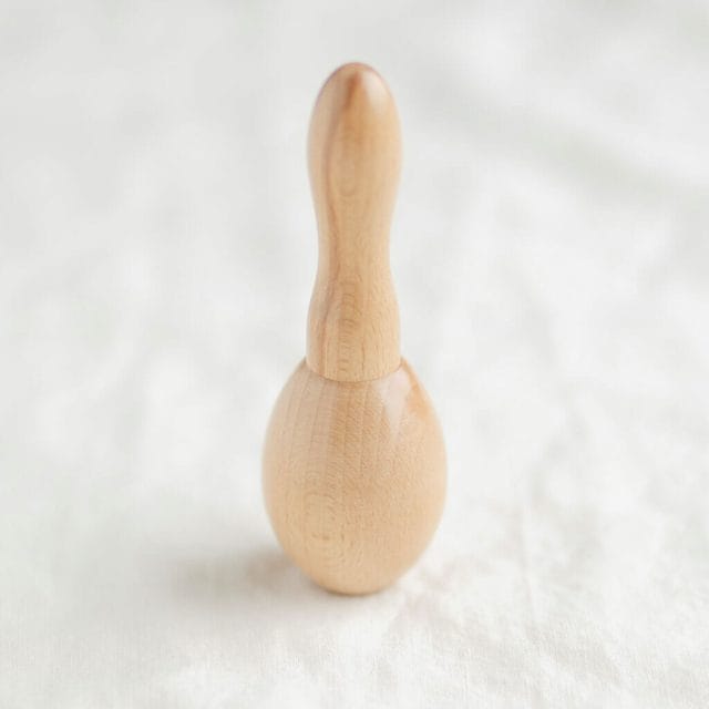 a wood darning egg with a handle