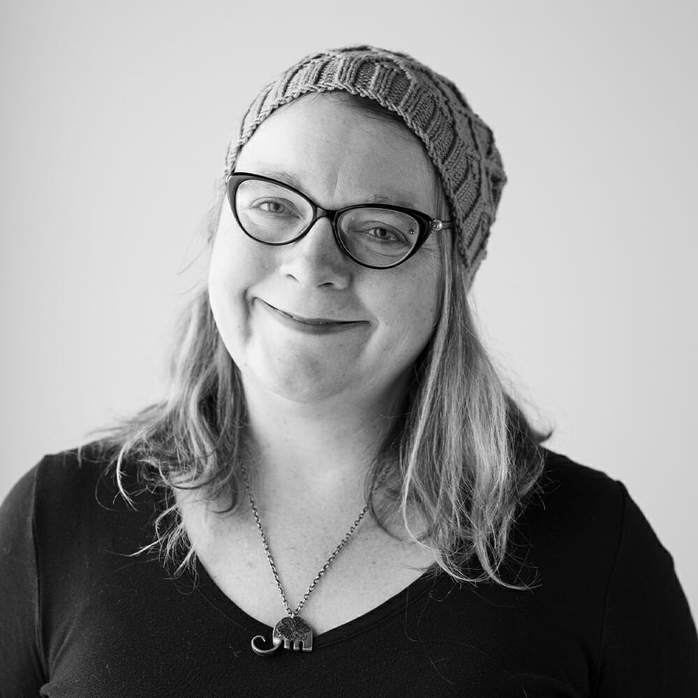 A photo of Stacey, a white woman with glasses and light hair.